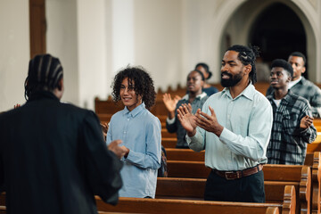 Congregation clapping along to gospel music in church