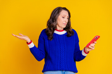 Photo of lovely pensioner lady hold device shrug shoulders dressed stylish blue knitted garment...