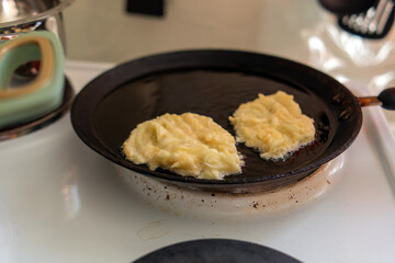 Delicious zucchini pancakes sizzling in a skillet, showcasing their golden-brown texture and inviting aroma. A perfect blend of healthy ingredients for a delightful meal