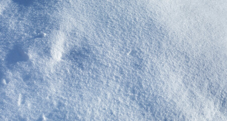 Light blue snow textured background wallpaper. Sunny winter weather abstract landscape pattern. Selective focus