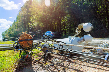 Strong hurricane caused fall down electric poles with broken wires during storm winds
