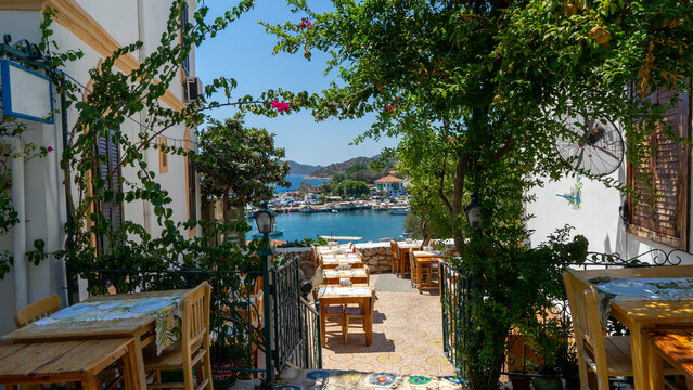 Outdoor cafe on veranda overlooking marina and Mediterranean Sea in city Kas, Turkey. Lunch or dinner with beautiful view