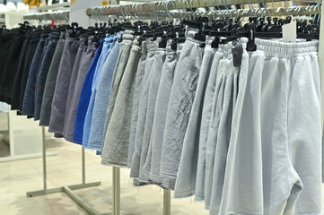 shorts on hangers are sold in a clothing store