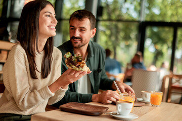 Enjoying a delightful brunch together at a cozy cafe on a sunny afternoon in the heart of the city