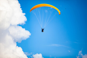 People paragliding over the beautiful mountains of the Antioquia department in Colombia. Tandem Paragliding. Extreme sport concept.