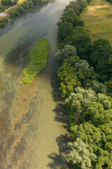 Aerial view of a serene river winding through lush greenery, highlighting the beauty of nature and tranquility in a scenic landscape.