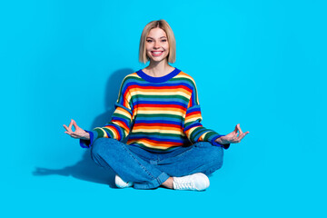 Full size photo of pretty young girl sit floor meditation wear trendy striped outfit isolated on...