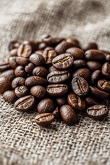 Fototapeta premium Freshly roasted coffee beans spread on burlap fabric in natural light just after brewing