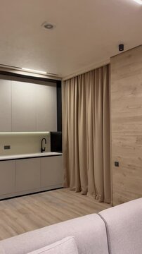 Elegant Modern Kitchen and Living Room Interior with Sleek Built-in Cabinets and Open-Plan Design. 4K ultra quality video. Kitchen video.