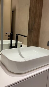 Close-up of Modern Sink with Black Faucet in a Minimalist Bathroom - Camera Pulls Back