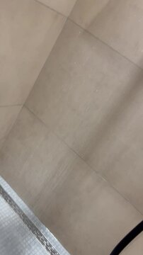 Shower Head with Water Flowing Down in Modern Bathroom