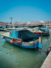 Traditional fisherman boats in a beautiful coastal town Marsaxlokk, Malta Island, Mediterranean Sea