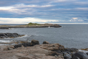 Rocky islands with waves crushing ocen view, Lofoten Norway