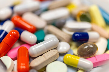 Colorful pills and tablets on white background