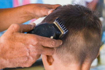 little boy gets a haircut at the salon