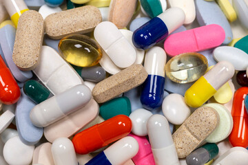 Colorful pills and tablets on white background