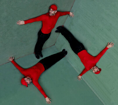 Multiple exposures of man posing inside geometric space