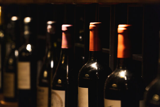Bordeaux wine bottles in a dimly lit cellar
