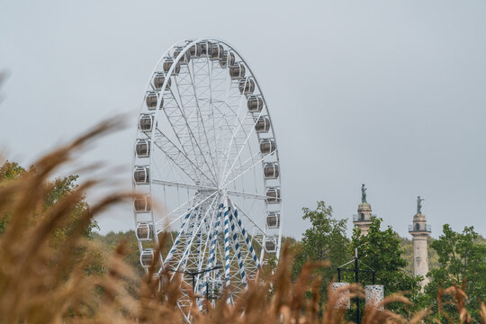Roue des Quinconces framed by autumn foliage in Bordeaux