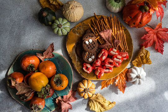 Assorted Halloween sweets with cookies and pumpkins