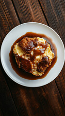 Delicious bread pudding dessert with caramel sauce on white plate and wooden table. Golden brown pastry contrasts beautifully. Perfect for any mealtime