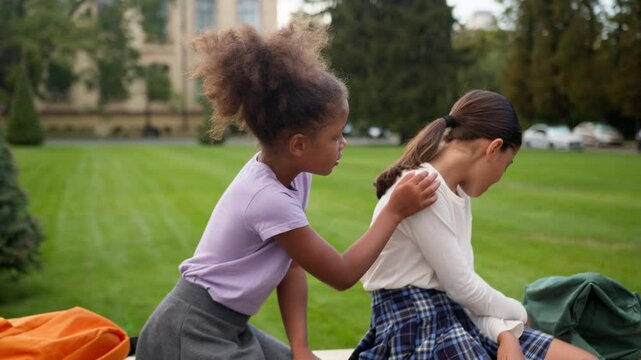 Friends breakup little girls kids children schoolgirls female pupils offended worried sad separated ignore African American classmate apologize multiethnic students school education quarrel conflict