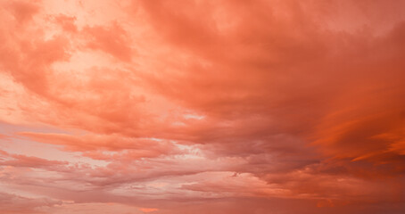 Beautiful colorful bright sunset sky with orange clouds. Nature sky background.