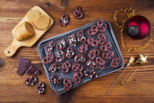 Home made marzipan pretzel cookie confection sweets glazed im dark chocolate with ice sugar topping