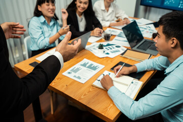 Diverse group of business analyst team analyzing financial data report. Finance data analysis chart and graph dashboard show on TV screen in meeting room for strategic marketing planning. Habiliment