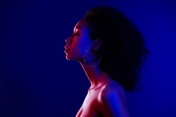 Photo of beautiful tender lady with bare shoulders isolated on blue neon color background