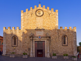 Taormina, Italy - May 24, 2024: Taormina Duomo facade of San Nikolas church in summer sunset colors...