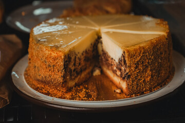 Cheesecake with brownie inside. Various types of mini desserts in a display case. Modern bakery or patisserie.