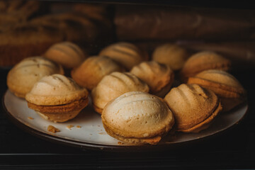 Modern bakery or patisserie. A display case of a bakery or coffeeshop. Various types of mini desserts in a display case. A dessert of nuts with condensed milk.