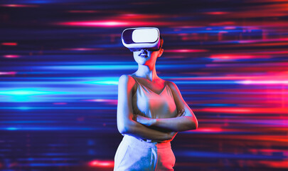 Smart female standing surrounded by neon light wearing VR headset connecting metaverse, future...