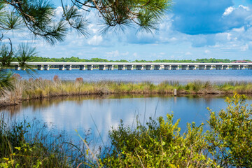 Phillips Inlet Bridge over the Powell Lake, Panama City Beach. It is on the Bay County and Walton County line, connecting 30A Scenic Highway and the coastal city. Overlooks to Gulf of Mexico