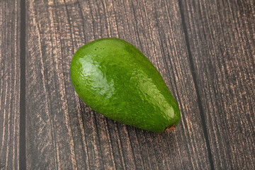 Ripe green avocado over background