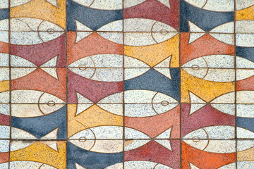 Puerto de Mogan, Gran Canaria, Spain. Colorful mosaic tiles with the image of fish on the sidewalk in the town