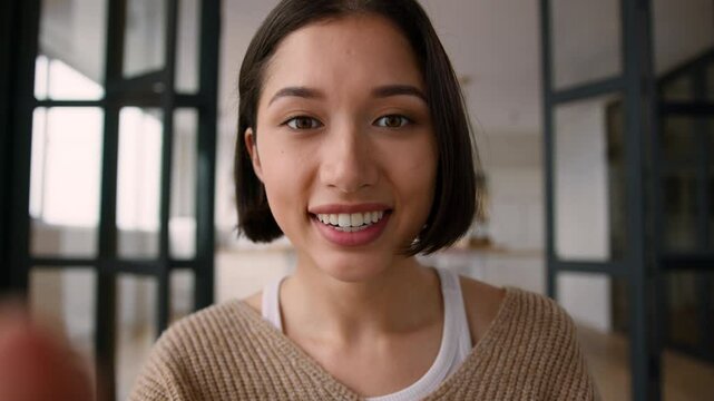 POV webcam point of view female girl addict influencer Caucasian smiling woman happy surprised read message online chatting using mobile phone touchscreen typing sms cellphone gadget screen at home