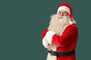 Santa Claus with crossed arms on green background