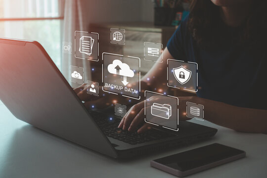 Businesswoman using a laptop computer to backup storage data Internet technology concept for backup online documentation database and digital file storage system or software, file access, doc sharing.