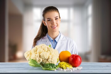 Portrait of young dietitian with fresh fruits and vegetables