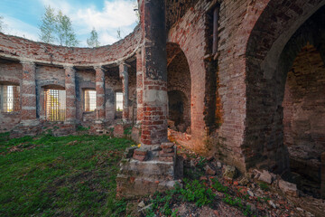 Old brick ruins of abandoned Church. Columned hall with collapsed roof