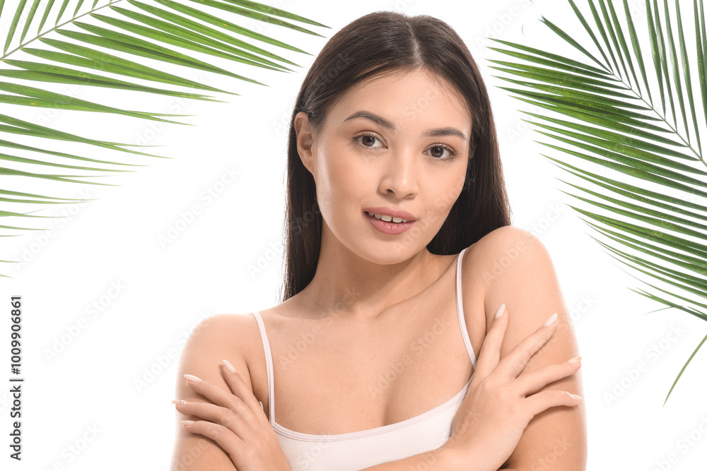 Wall mural Young Asian woman with palm leaves on white background, closeup