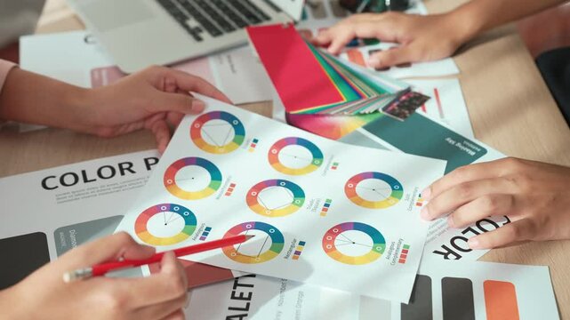 Slow motion hand closeup of two designer brainstorming and choosing color for graphic design working or client asking advise with chromatic consultation at designer agency office. Variegated