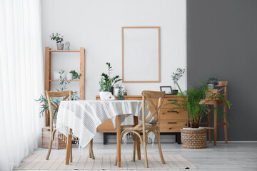 Interior of light dining room with table, chairs and shelving unit near white wall