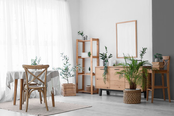 Interior of light dining room with table, chairs and shelving unit near white wall