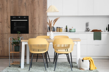 Interior of modern dining room with table and chairs