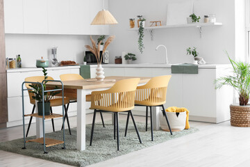 Interior of modern dining room with table and chairs