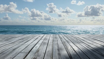 Obraz premium Wooden pier leading to a vast ocean under a blue sky with white clouds.