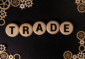 text TRADE made of wooden cubes and different words on white background